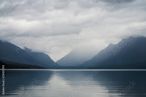 The mountains in the distance at Macdonald Lake, Montana, covered with clouds and fog.