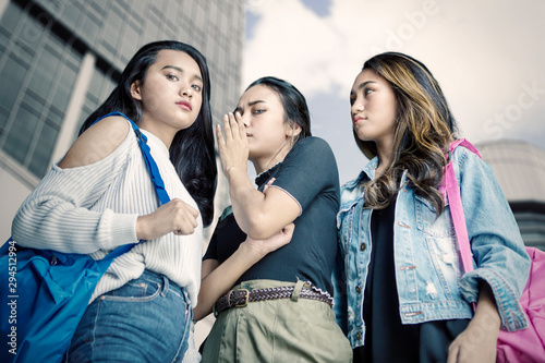 Group of female teenagers gossiping somebody © Creativa Images