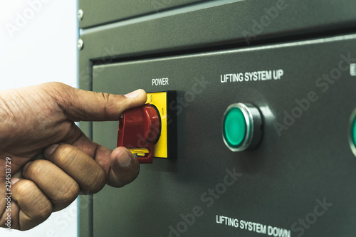 Obraz na plátne Close up of Worker hand twist main power switch before operating testing machine