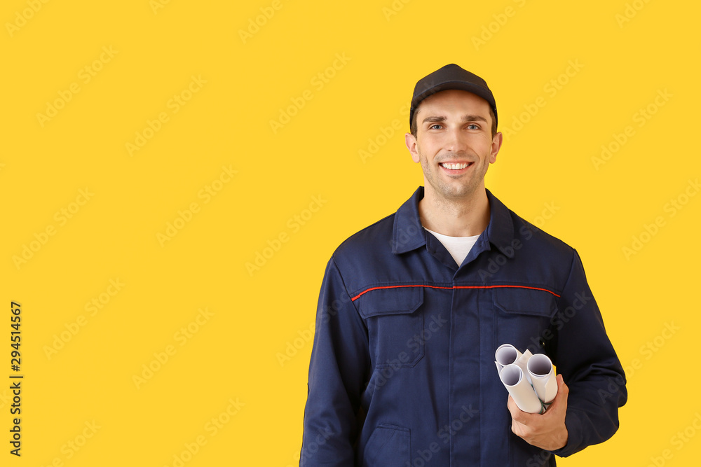 Male car mechanic with drawings on color background Male car mechanic with drawings on color background