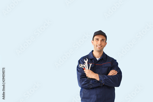Male car mechanic on color background photo