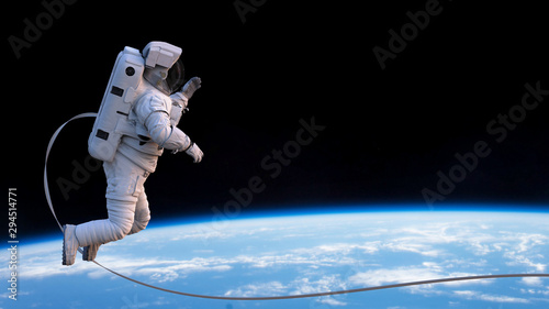 Fototapeta Naklejka Na Ścianę i Meble -  astronaut with safety tether performing a spacewalk in empty space 
