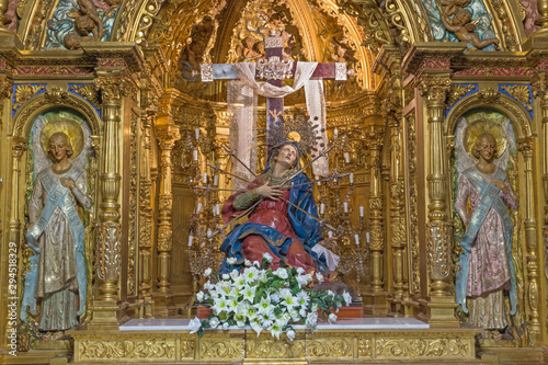 SALAMANCA, SPAIN, APRIL - 17, 2016: The carved polychrome baroque altar of Our Lady of Sorrow (Capilla de los Dolores) in church Iglesia de la Vera Cruz by unknown artist (1718). photo