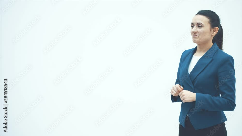 Young good looking teacher teacher lady showing finger class. On a white background. Dressed and blue jacket. Young good looking teacher teacher lady showing finger class. On a white background. Dressed and blue jacket.