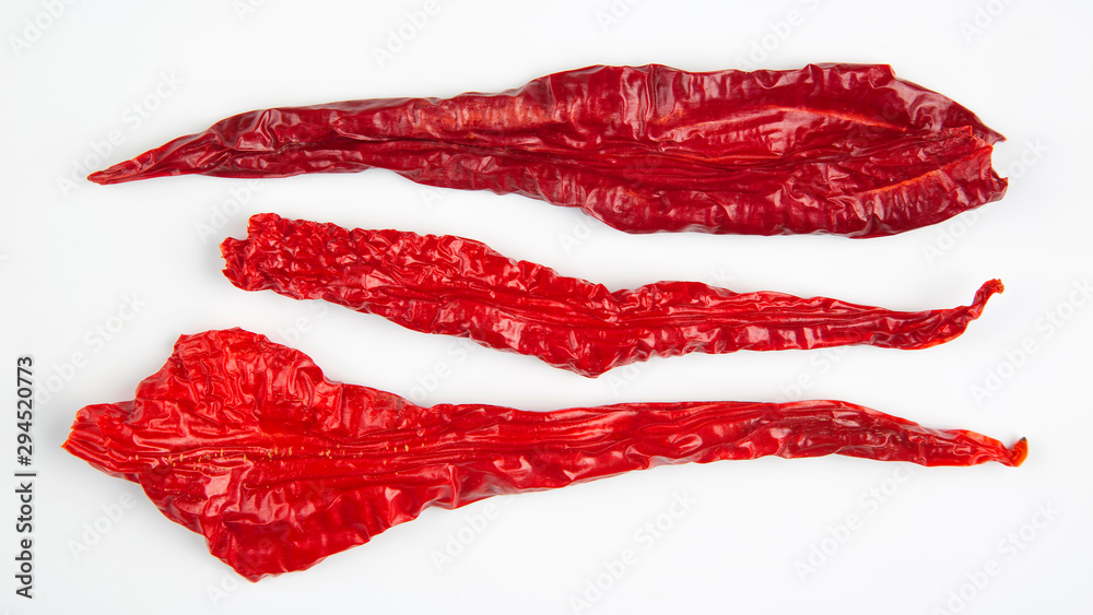 Dried hot red pepper on a white background. Food and spices. Dried hot red pepper on a white background. Food and spices.