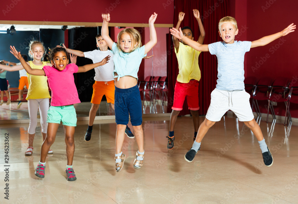Happy children jumping while studying dance