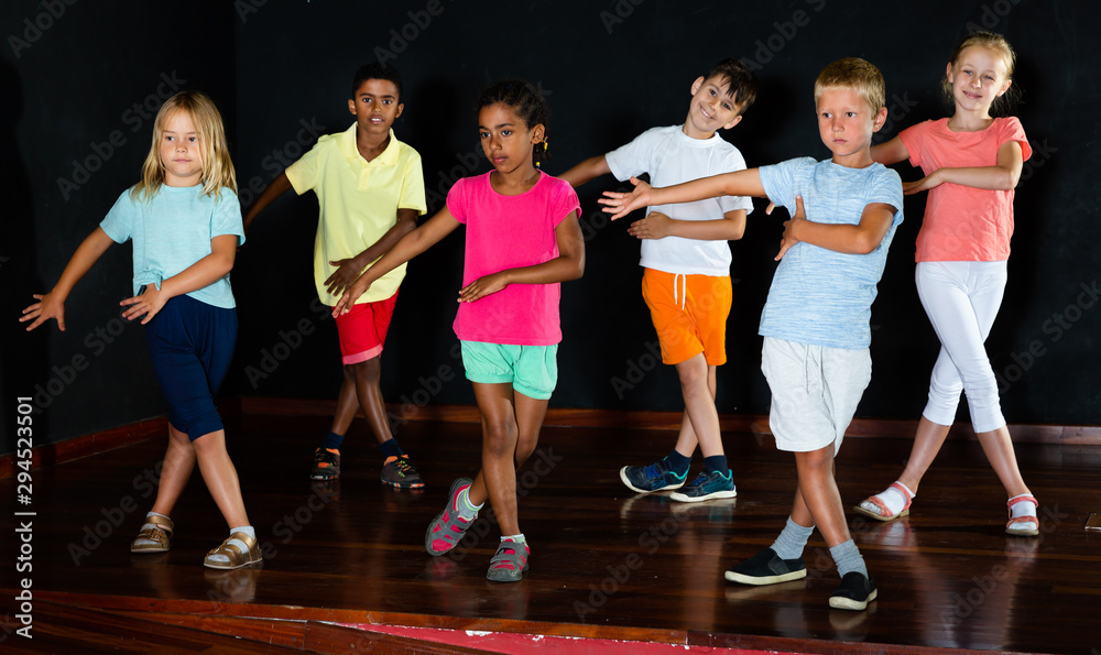 Children studying modern style dance in class