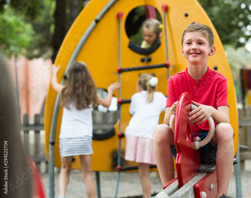 cheerful boy on children's playground.