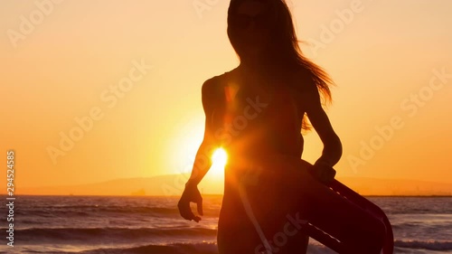 Female lifeguard running along the beach