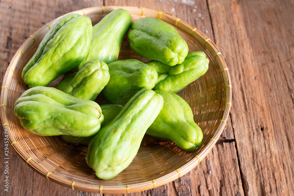 Fresh chayote fruits (Sechium edulis) on wood background Fresh chayote fruits (Sechium edulis) on wood background