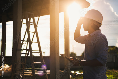 Male architect inspecting building house construction  worker at development site