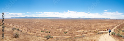 Family walking at Wallace Creek Trail, San Andreas Fault, Carizzo Plain National Monument on sunny spring day, Kern County, California, Central Valley