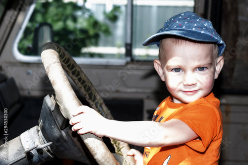 Child driving an old car