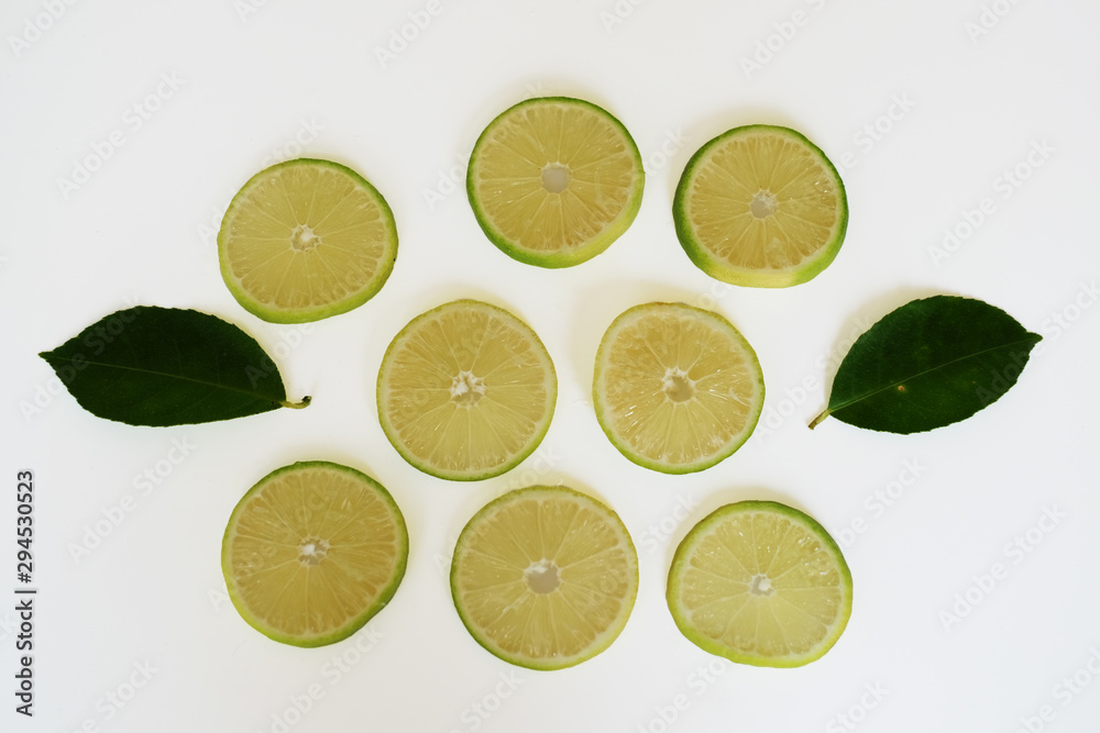 Lemon sliced with leaves isolated on white background.