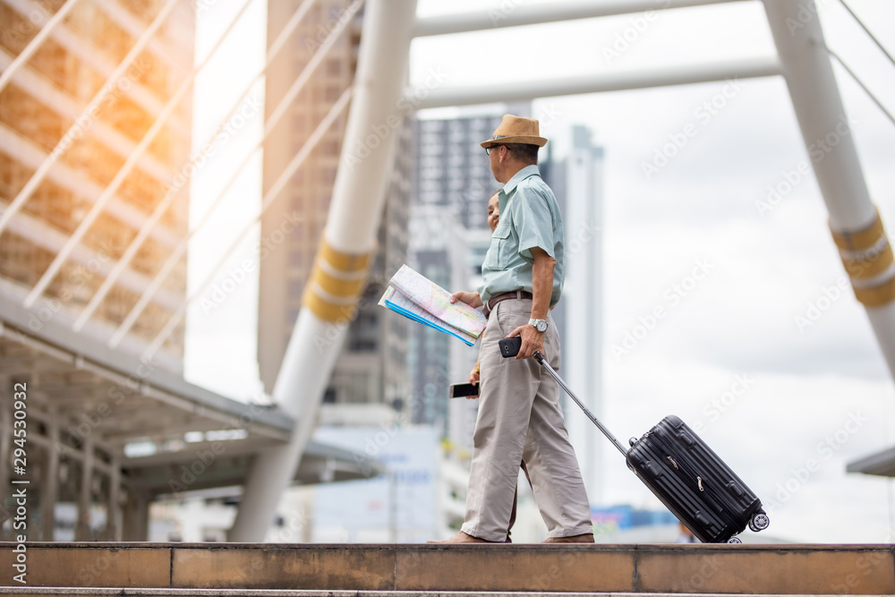senior traveler walking in city with map