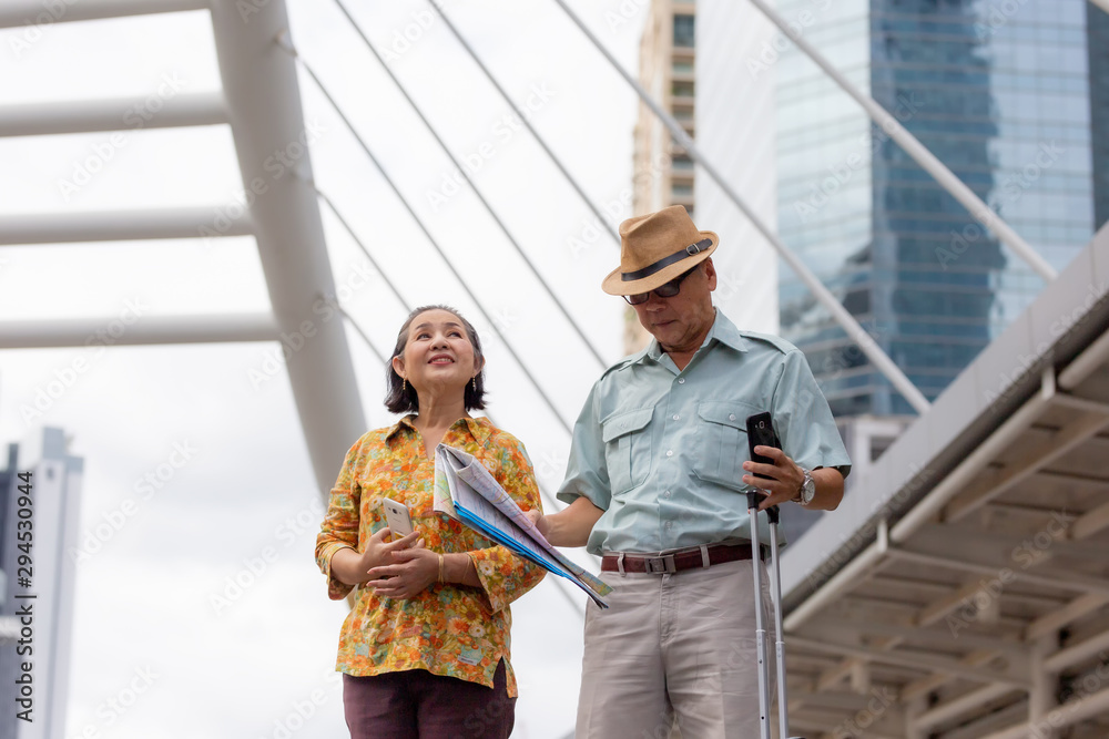 senior traveler walking in city with map