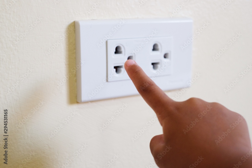 Close up kid put her finger in to electrical socket. child at risk of  electric shock. Safety concept. Stock Photo | Adobe Stock
