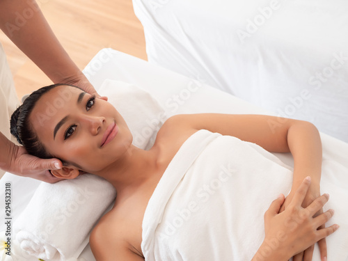 Asian girls are a relaxing head massage in the Spa Salon. Thai massage for health