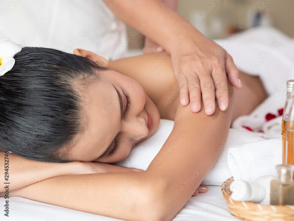 Beautiful young asian woman lying relaxing and smile on the bed mattresses In the Spa. Thai massage for health. Select focus face women Beautiful young asian woman lying relaxing and smile on the bed mattresses In the Spa. Thai massage for health. Select focus face women