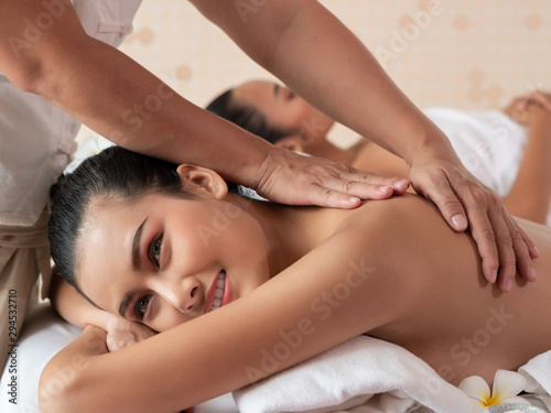 Beautiful young asian woman lying relaxing and smile on the bed mattresses In the Spa. Thai massage for health. Select focus face women