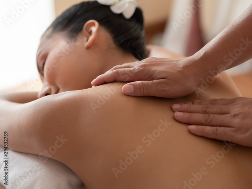 Hand of masseuse s on the backs of women. Asian woman are a relaxing on the bed. Massage and body care. Spa in salon