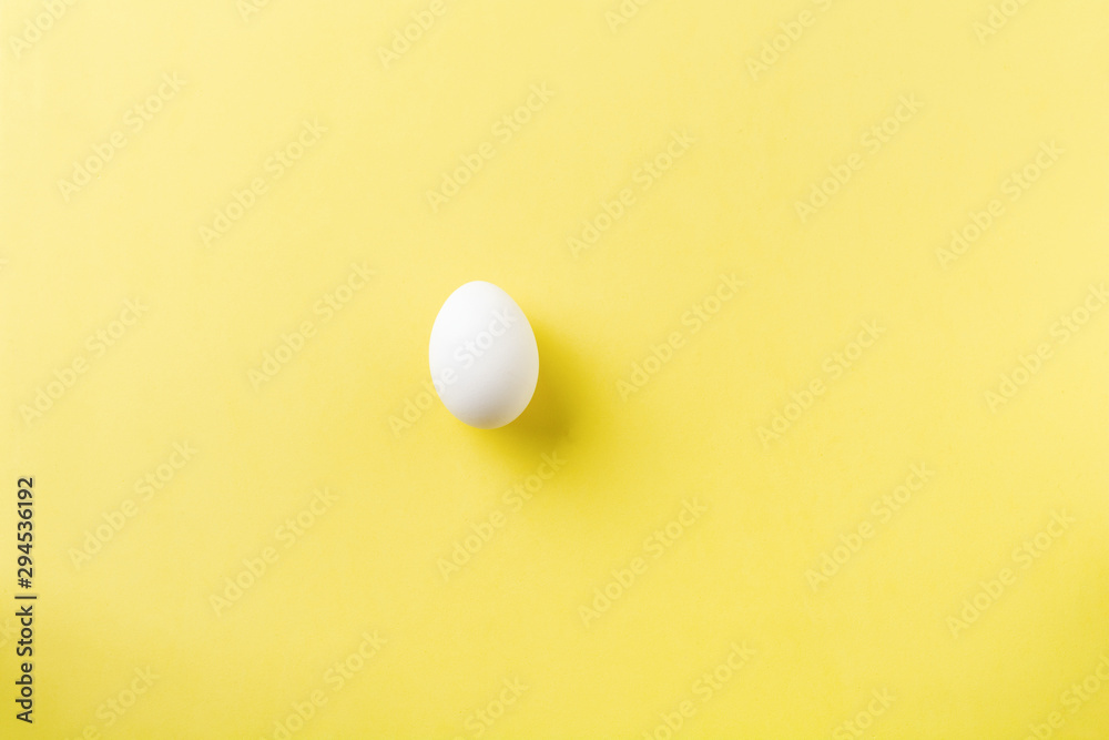 White raw chicken eggs lying on light concrete background. Top view.