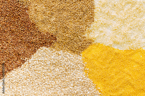 Cereals - rice, buckwheat, oats, millet and barley - background top view copy space
