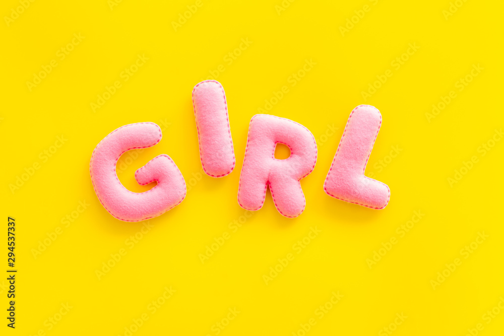 Naklejka premium Girl word as decoration for baby shower on yellow background top view