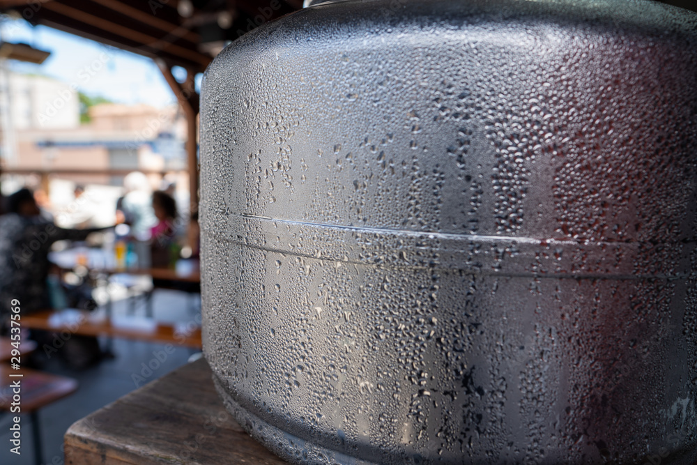 Water jug sitting in restaurant filled with cold water covered in condensation Water jug sitting in restaurant filled with cold water covered in condensation
