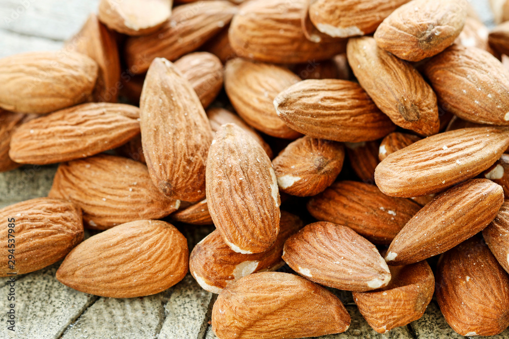 Almonds on rough wooden background, raw fruits. Almonds on rough wooden background, raw fruits.