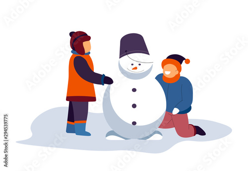 Boys building snowman with bucket on top