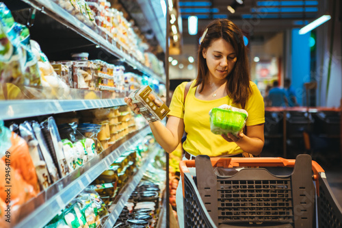 young pretty adult woman do shopping in grocery store photo