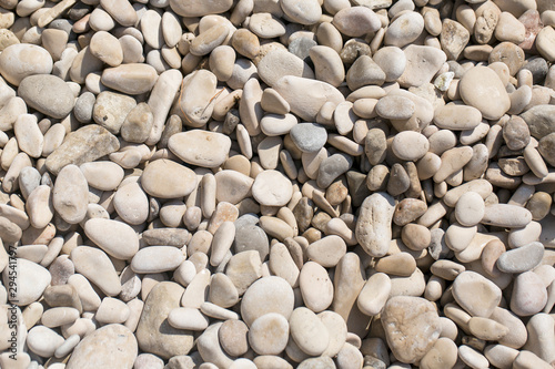 Stony beach by the sea, background of small stones, close up