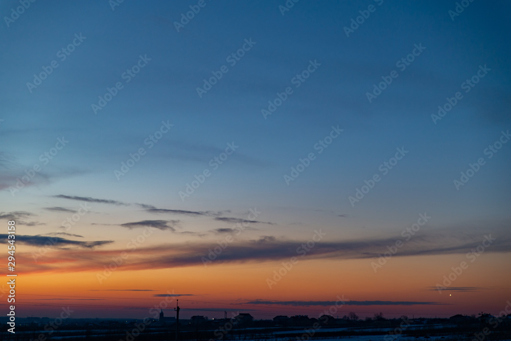 view of winter sunset over snowed field