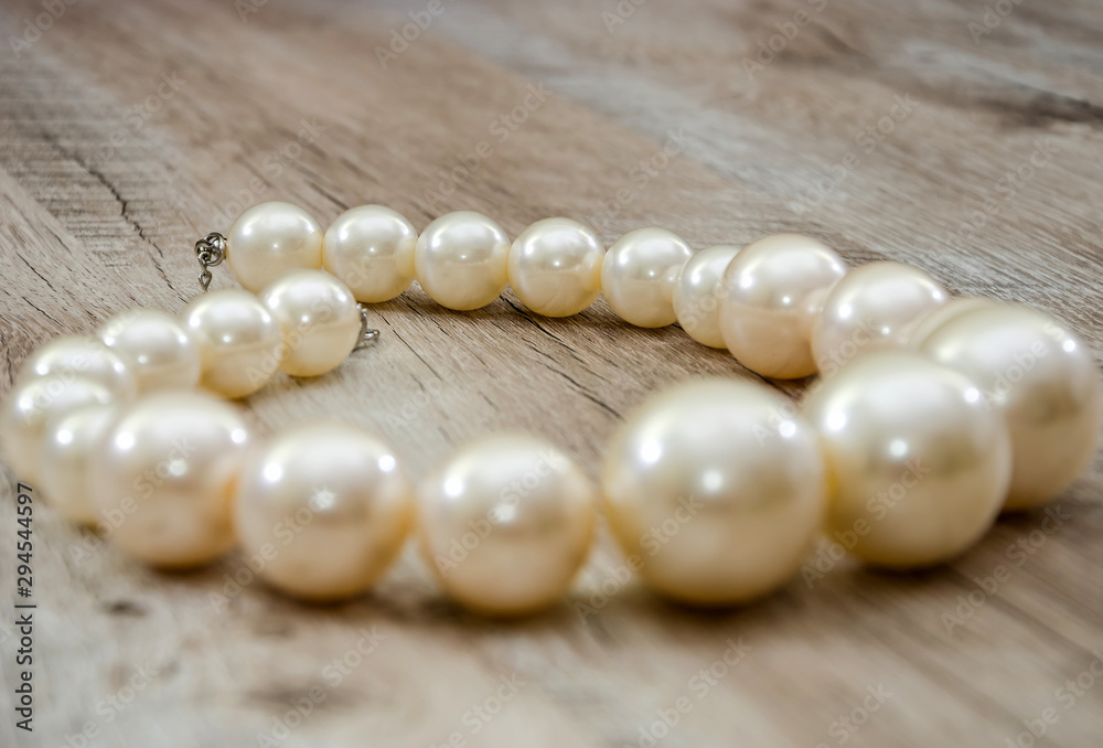 necklace on a wooden background, close-up. Beautiful, feminine decoration. necklace on a wooden background, close-up. Beautiful, feminine decoration.