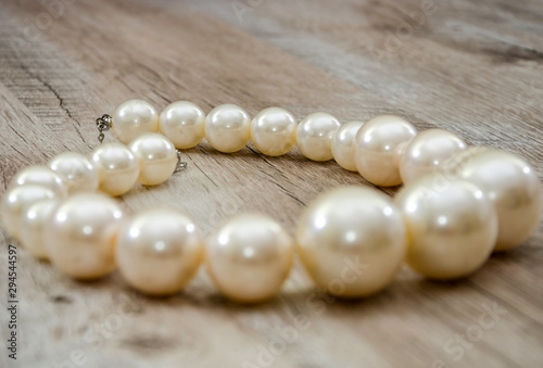 necklace on a wooden background, close-up. Beautiful, feminine decoration.