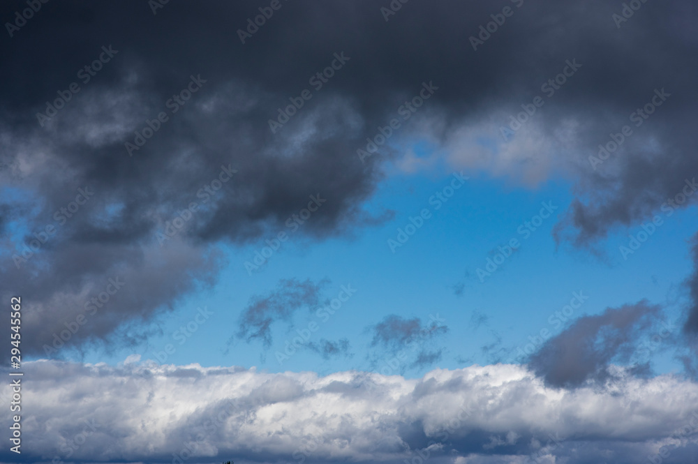 cloudscape with blue sky white clouds at the horizon
