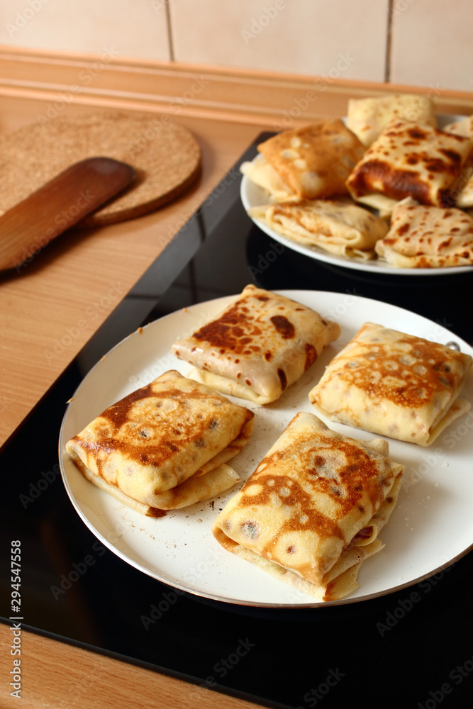 Frying pancakes with fillings. Traditional russian pancakes (blini) with curd. Cheese blintzes.
