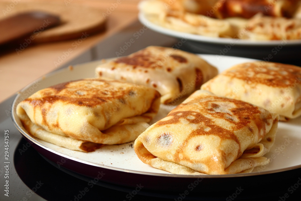 Frying pancakes with fillings. Traditional russian pancakes (blini) with curd. Cheese blintzes.