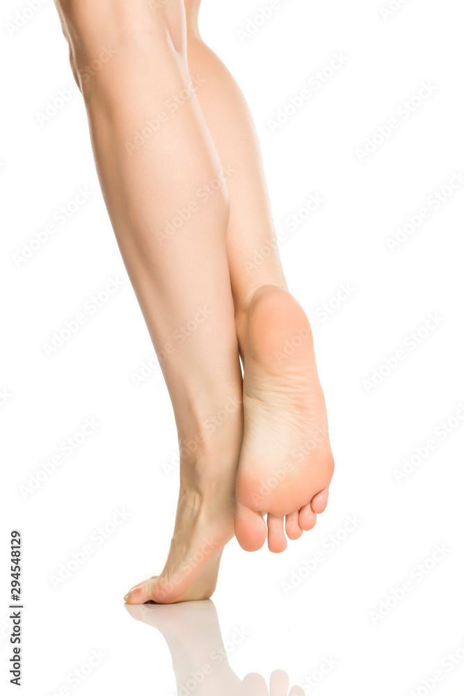 Female feet in nylon hosiery on white background