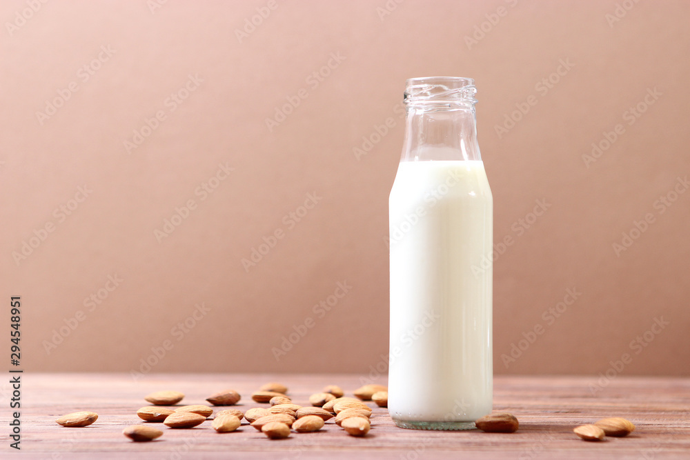 Almond milk and almonds on the table. Vegetable milk. Vegetarian milk. Almond milk and almonds on the table. Vegetable milk. Vegetarian milk.