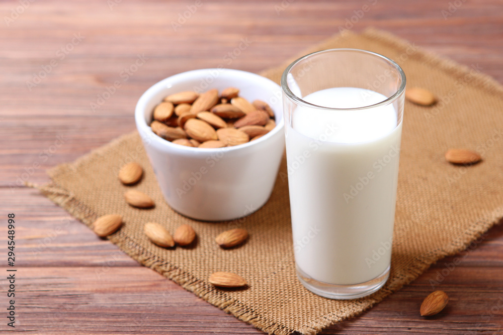 Almond milk and almonds on the table. Vegetable milk. Vegetarian milk. Almond milk and almonds on the table. Vegetable milk. Vegetarian milk.