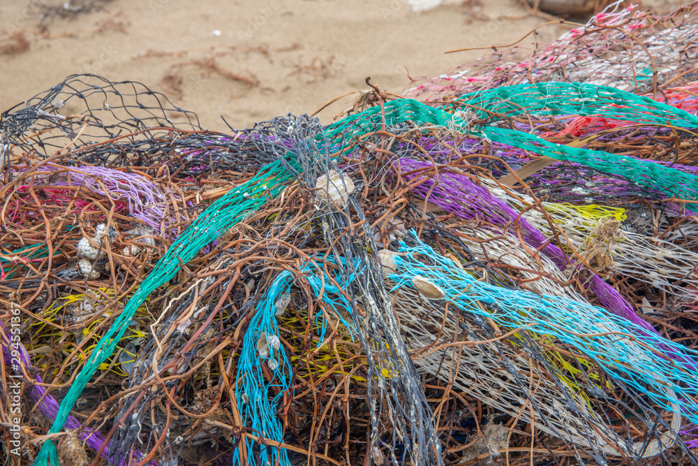 Colorful nets on beach. Trash in nature. Ecology crisis concept Colorful nets on beach. Trash in nature. Ecology crisis concept