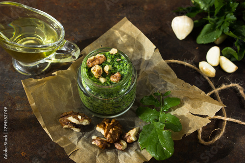 Homemade basil pesto with pine nuts, parmesan and garlic. Green pesto sauce in a glass bowl