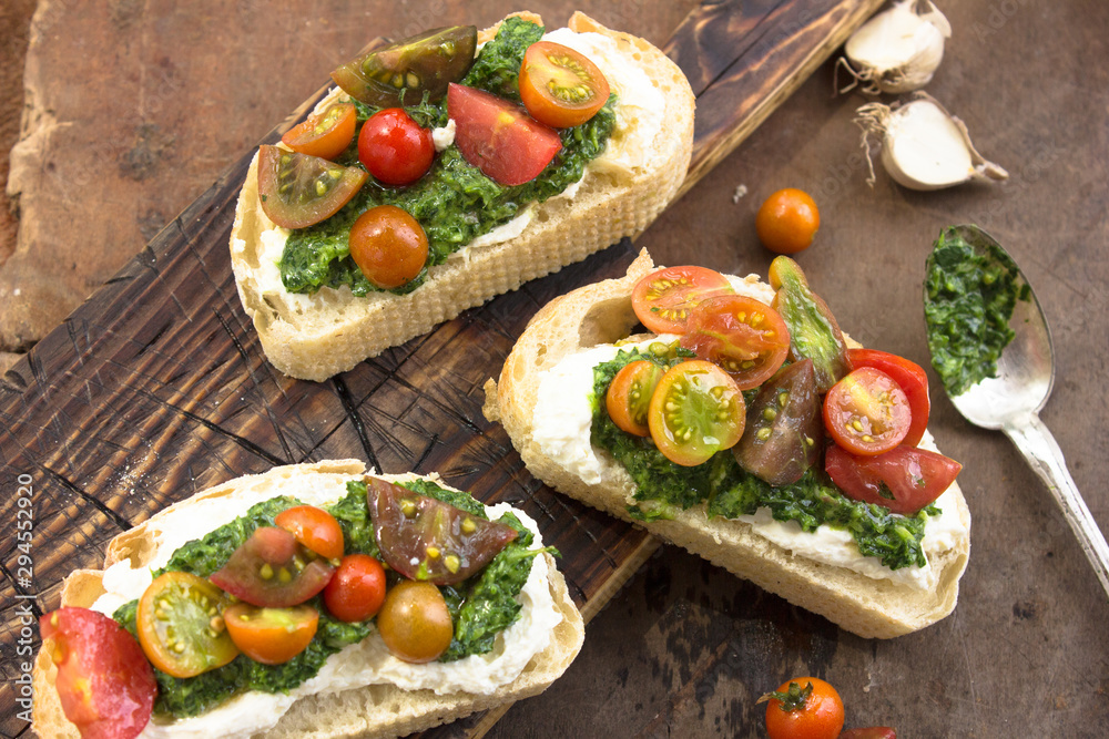 Appetizing bruschetta.Traditional italian bruschetta.Open sandwich with source pesto and tomato Appetizing bruschetta.Traditional italian bruschetta.Open sandwich with source pesto and tomato