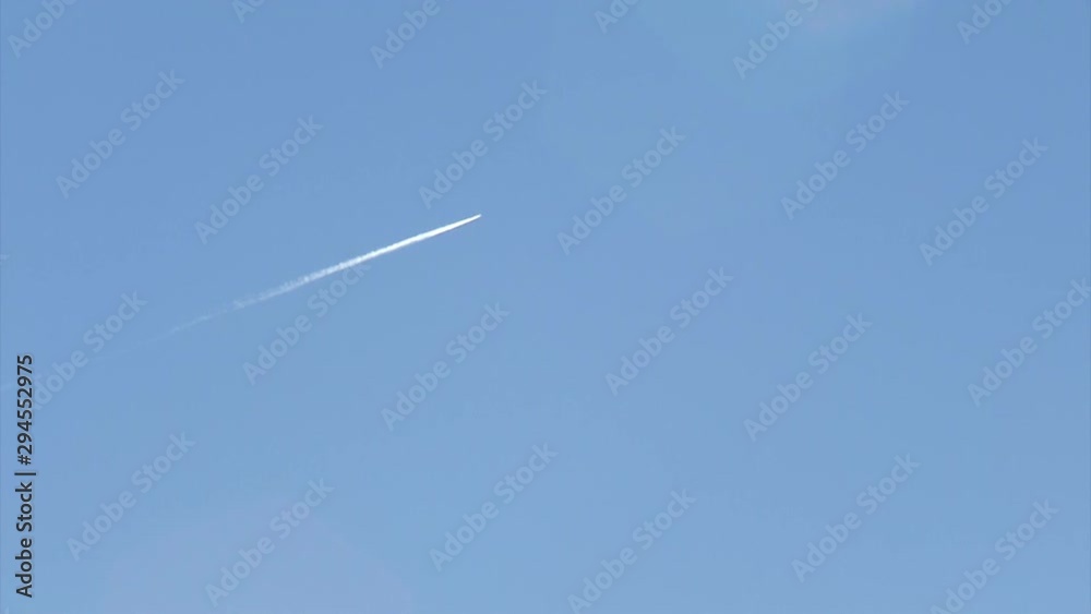 Airplane up in the sky leaving behind a long contrail Airplane up in the sky leaving behind a long contrail