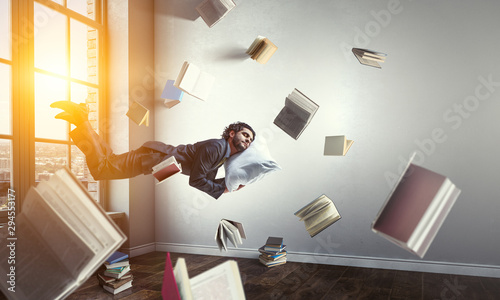 Joyful happe businessman levitating horizontally © Sergey Nivens