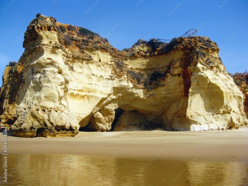 Algarve coast with rocky formations. Atlantic coast landscape in Algarve region. Seashore and caves near Portimao, Portugal, Europe