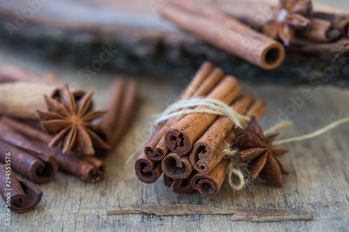 Heap of cinnamon sticks and ground cinnamon with dust effect. Aromatic spice.