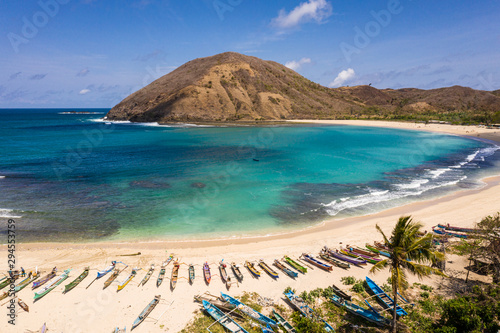 Idyllic Mawun beach in the Kuta area of south Lombok in Indonesia with traditional fisherman boats. photo